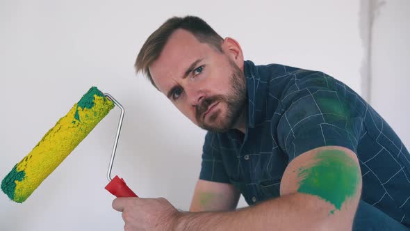 Emotional Constructor Shows Roller with Yellow Paint in Room alt