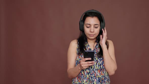 Modern Adult Enjoying Mp3 Radio Music on Wireless Headphones alt