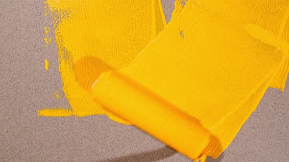 Abstract Brushstrokes of Yellow Paint Brush Roller Applied Isolated on a Gray Background alt