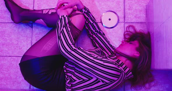 apathy, depression - depressed girl lying on the floor with torn pantyhose alt