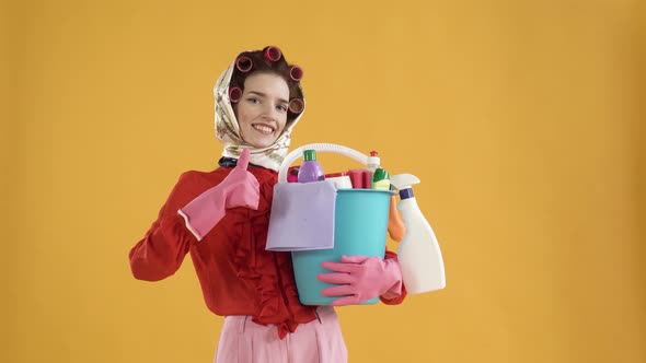 A Woman with a Bucket of Household Chemicals Shows a Thumbs Up Gesture