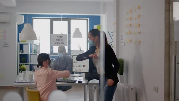 Coworkers Touching Elbow to Avoid Infection with Coronavirus alt