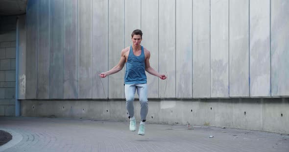 Athletic Man Training Jump Exercise on Skipping Rope on Workout alt