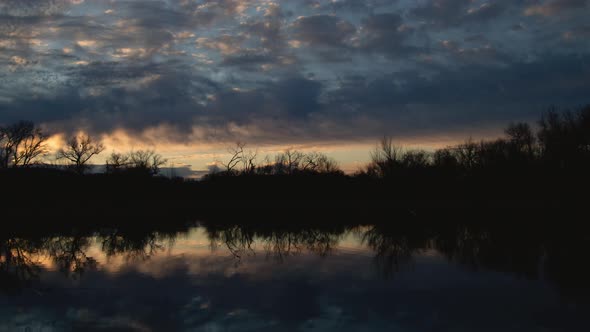 Brilliant Clouds Over Lake Before Sunrise Timelapse Zoom Out