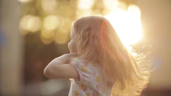 Girl Twirling and Posing with Beautiful Long Hair in Park