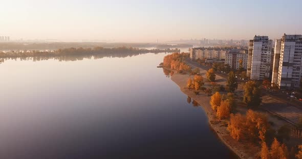 Flight Over the Bay in Autumn, Yellow Foliage and City Outskirts. Ukraine, Kiev