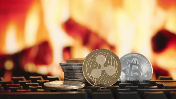 Cryptocurrency Ripple and Bitcoin on Blurring Background of Fire alt