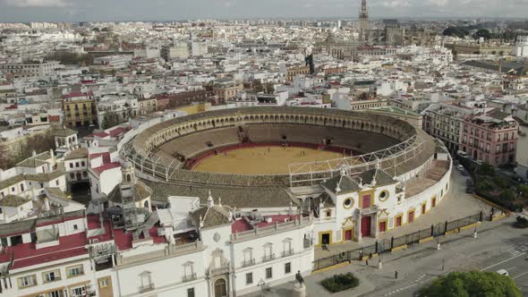 Plaza de Toros or bullring and cityscape, Seville in Spain. Aerial circling