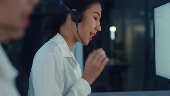 Asia young call center team or customer support service executive using computer and microphoneใ