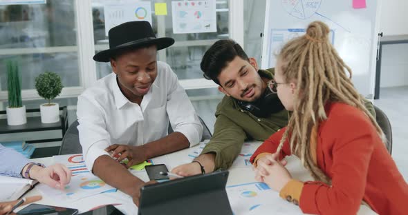 Team which Analyzing Datas on Tablet pc and Deciding Business Strategy of Project alt