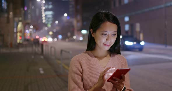 Woman use of mobile phone at night alt