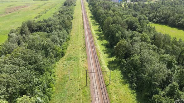 Train Way, Railroad tracks Through Green Grassed Countryside, Aerial. alt