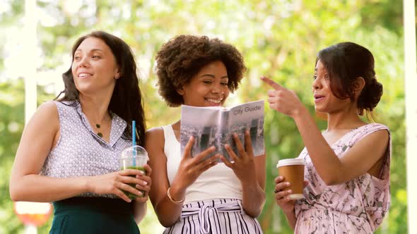 Women with City Guide and Drinks on Street alt