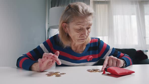 Elderly Caucasian Woman Counting Small Amount of Coins Left From Her Pension alt