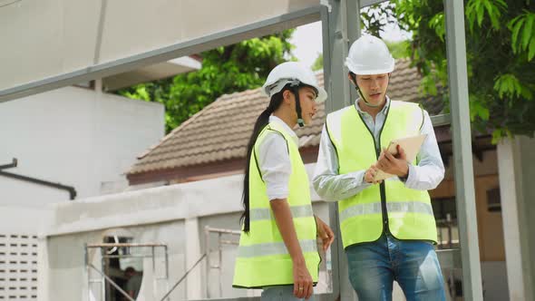 Asian colleague construction workers people wearing protective safety helmet and glasses on site. alt