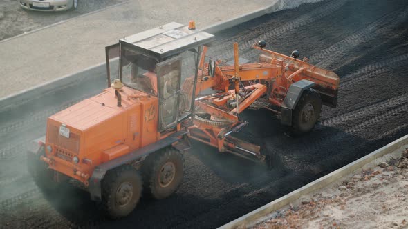 Road works with an asphalt paver. Special road equipment alt