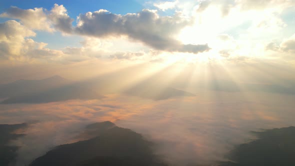 Aerial view from drone, Epic sunbeam over clouds mountains. 4K aerial shot on sunrise alt