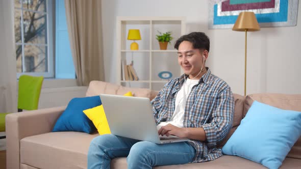 Stylish Young Hipster Asian Student Waving Hand To Laptop Talking on Video Call alt