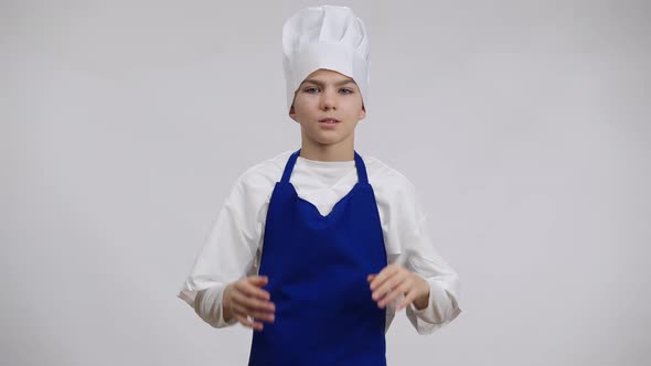 Stressed Little Cook Rubbing Temples Pulling Chef Hat on Head alt