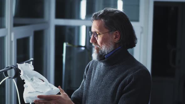 Male Designer Examining 3D Model alt