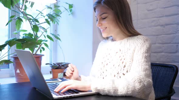 Web Video Chat on Laptop By Young Female Sitting In Office alt