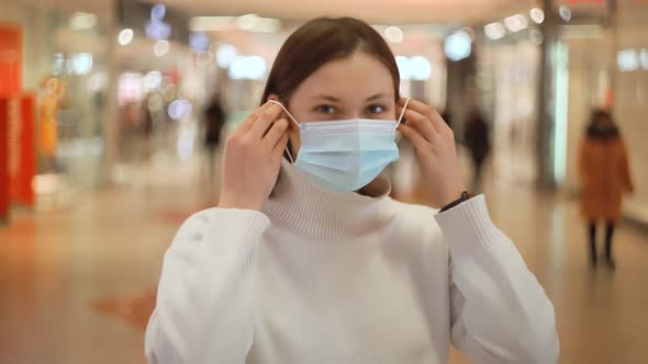 Woman in Public Place Puts on Mask Safety Precaution Security Measures Health