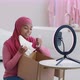 Young Happy Muslim African American Woman Wearing Hijab Recording Video Review About New Sneakers at - VideoHive Item for Sale