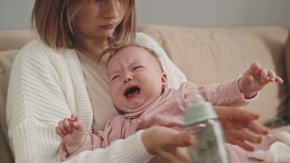 Mom Giving Water to Crying Baby, Stock Footage VideoHive