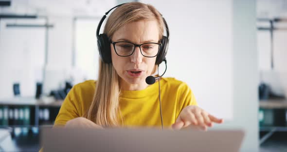 Woman in Headset Working at Call Center