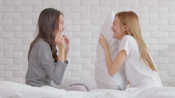 Beautiful asian young lesbian LGBTQ couple or friends touching cheek and looking together smile and alt