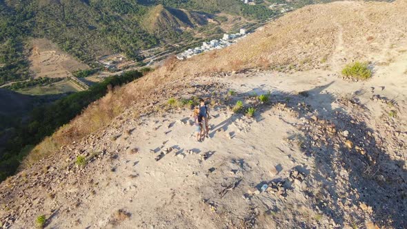 Aerial Shot of a Family Trekking in Mountains Called Three Sisters Overlooking the City of Nha Trang alt