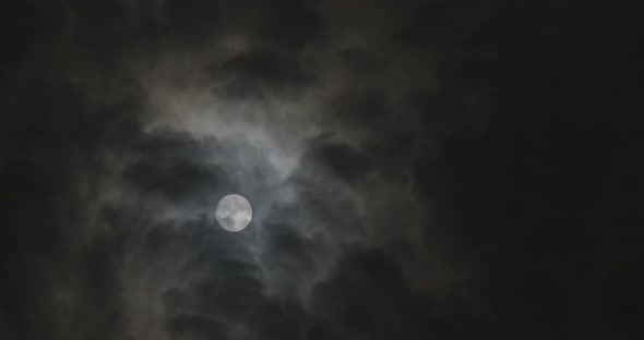 Moon at night with moving clouds