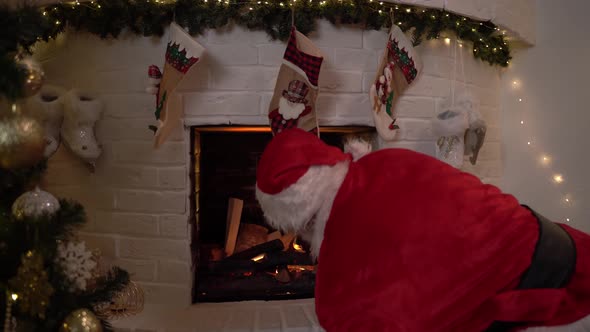 Funny Santa Claus Is Sitting By the Fireplace and Does Not Know How To Get There. Santa Claus Was