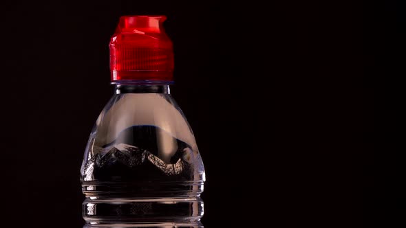 Water bottle on turntable on black background