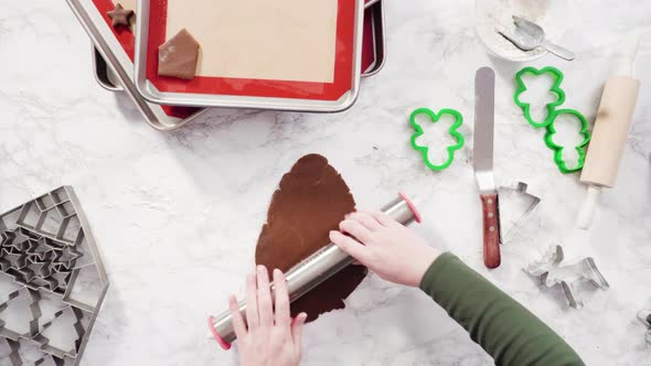 Flat lay. Step by step. Rolling out gingerbread cookie dough to bake Christmas cookies. alt