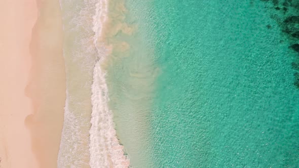 Beach and Azure Sea with Waves From Top View