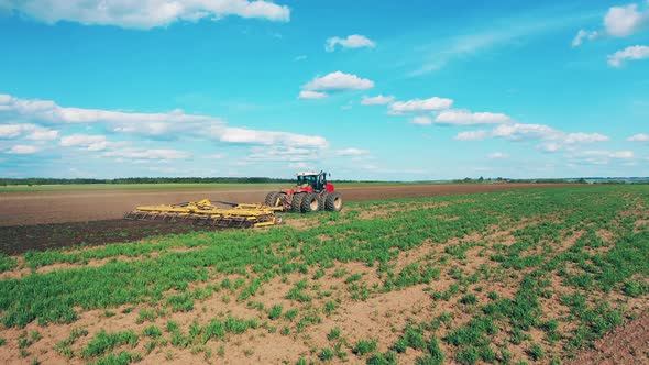 Industrial Tractor Plows Big Field. alt