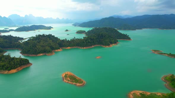 An aerial view from a drone flying over a dam, beautiful turquoise water alt