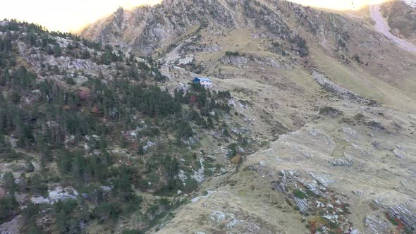 Refuge Espingo shelter at Lac d'Espingo lake in Haute-Garonne, Pyrénées, France, Aerial approach sho alt