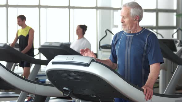 Senior Man Running on Treadmill. alt