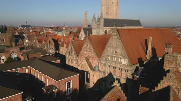 Historic buildings near Church of Our Lady line a canal in Bruges alt