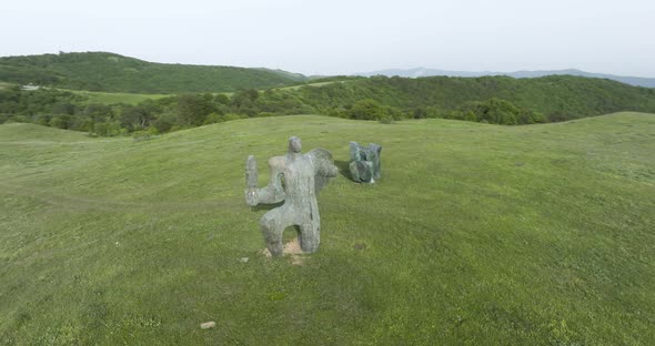 Aerial shot of a stone sculpture of a warrior, located in the Didgori Valley. alt