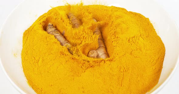 Turmeric, curcuma longa, Root falling on curcuma Powder, Indian Spice, Slow Motion 4K alt