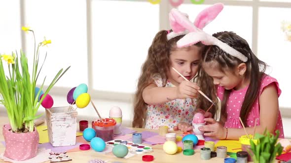 Happy Children Wearing Bunny Ears Painting Eggs on Easter Day