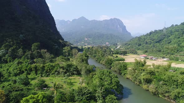 River near town of Vang Vieng in Laos seen from the sky alt