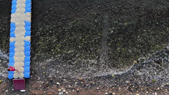 Aerial View of Plastic Modular Pontoons in the Sea and Rows of Sun Loungers with Vacationers on the alt