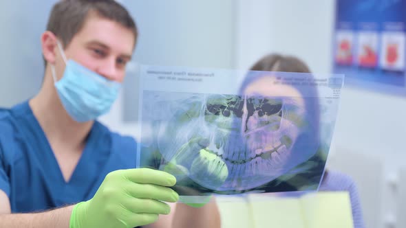Dentist Show Panoramic Mouth Xray Image To Patient