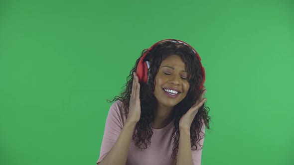 Portrait of Beautiful African American Young Woman Is Looking at Camera and Dancing and Enjoying alt