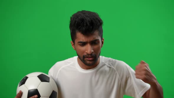 Portrait of Worried Dissatisfied Middle Eastern Man with Football Ball Talking Gesturing Looking at alt