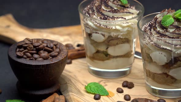 Classic Tiramisu Dessert in a Glass on Dark Concrete Background alt